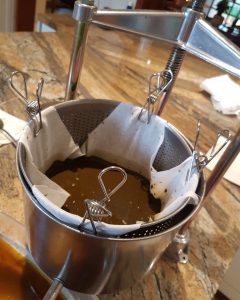 Winepress lined with a muslin cloth and a tincture inside